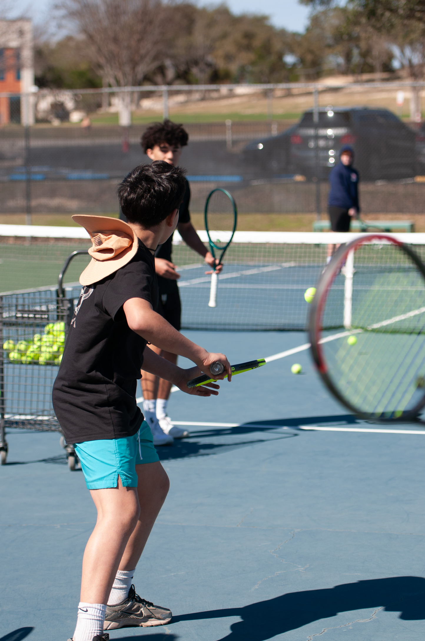 A young player mid-rally at a Tennis4All clinic