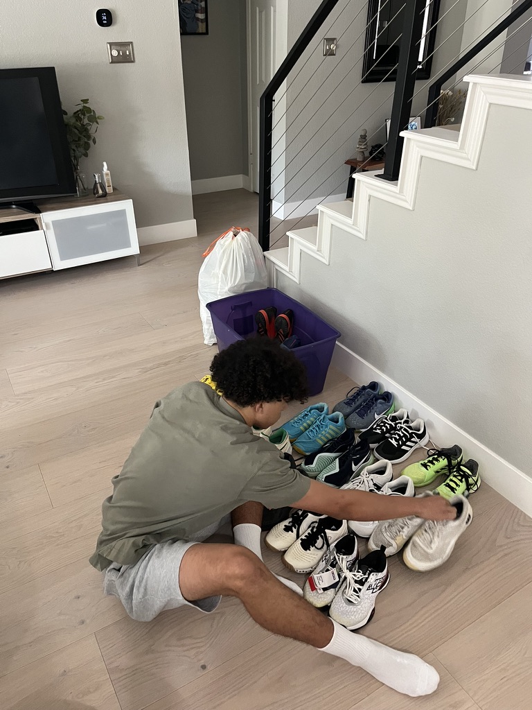 Sorting donated tennis shoes for redistribution